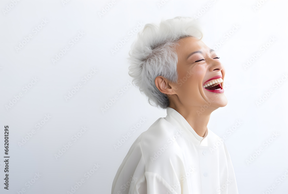 Portrait of an older happy laughing woman with grey hair on a white background Portrait of an older happy laughing woman with grey hair on a white background