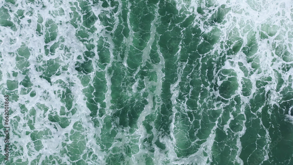 Powerful sea waves foaming drone top view. Stormy grey water making white foam