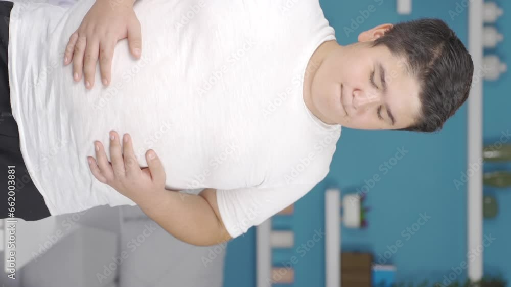 Vertical Video of Obesity boy is hungry and craving food. Vertical Video of Obesity boy is hungry and craving food.