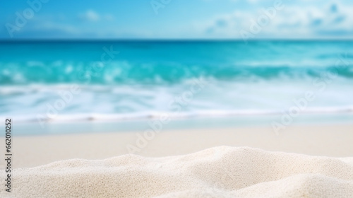 Close-up of pure white sand with blurred blue waves in the background