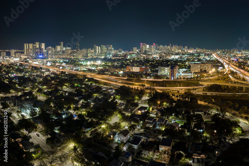 View from above of american big freeway intersection in Miami, Florida at night with fast moving cars and trucks. USA transportation infrastructure concept