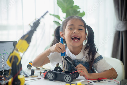 STEM education concept. Asian young girl learning robot design.