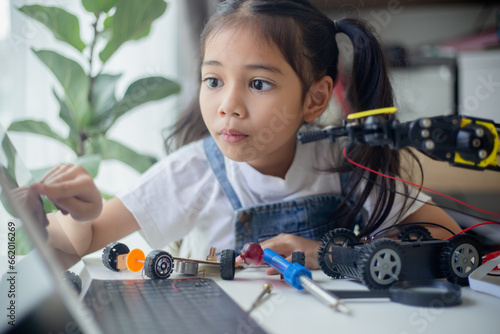STEM education concept. Asian young girl learning robot design.