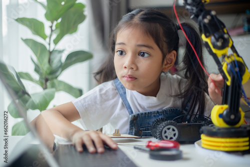 STEM education concept. Asian young girl learning robot design.