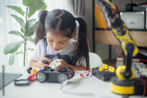 STEM education concept. Asian young girl learning robot design.