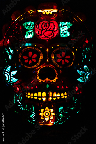 sugar skull made of pumpkins illuminated with colourful