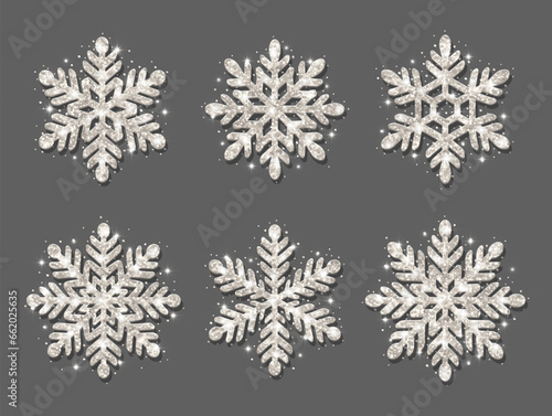 Set of snowflakes. Silver glitter texture. Christmas decoration. Shining silver snowflakes on a gray background.