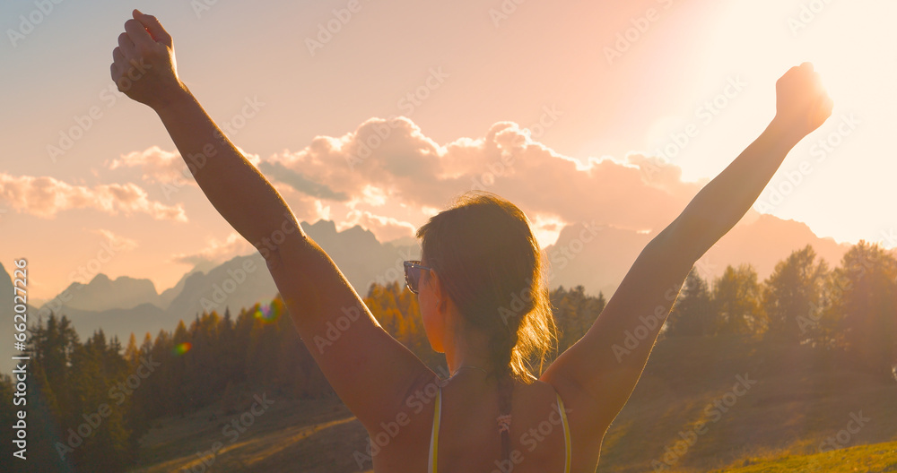 CLOSE UP, LENS FLARE: Victorious moment of a lady reaching beautiful mountaintop - obrazy, fototapety, plakaty 