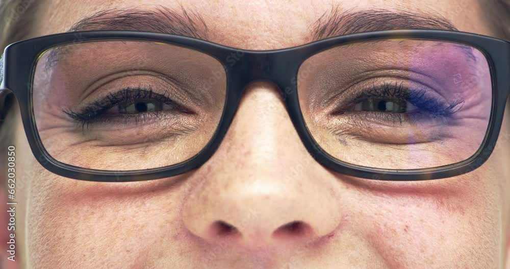 Glasses, vision and portrait closeup of a woman in a studio with blue eyes with her pupils and cosmetic makeup. Macro zoom of a happy female person with optical eyesight spectacles for prescription. Glasses, vision and portrait closeup of a woman in a studio with blue eyes with her pupils and cosmetic makeup. Macro zoom of a happy female person with optical eyesight spectacles for prescription.