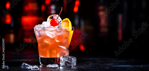 Photography Matador cocktail drink with whiskey, vermouth, liqueur, bitter, grenadine, orange juice, cherry and ice