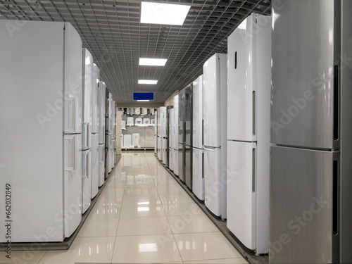 Rows of refrigerators in a home appliance and electronics store. The choice of refrigerators for buyers. Modern household appliances