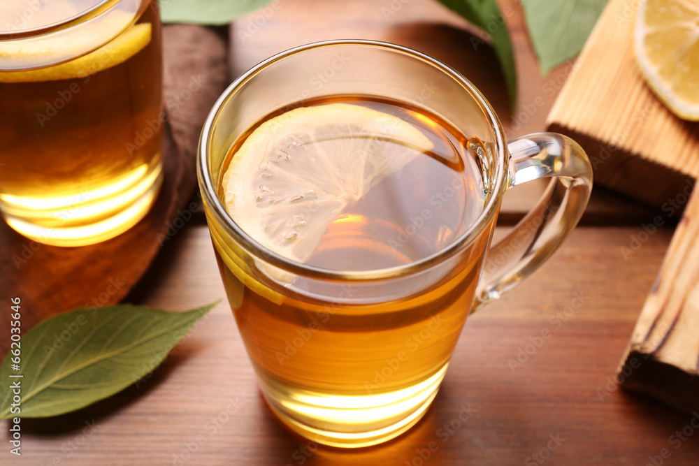 Cups of tasty iced tea with lemon on wooden table, closeup Cups of tasty iced tea with lemon on wooden table, closeup