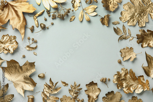 Frame made of different golden leaves on light grey background, flat lay with space for text. Autumn decor