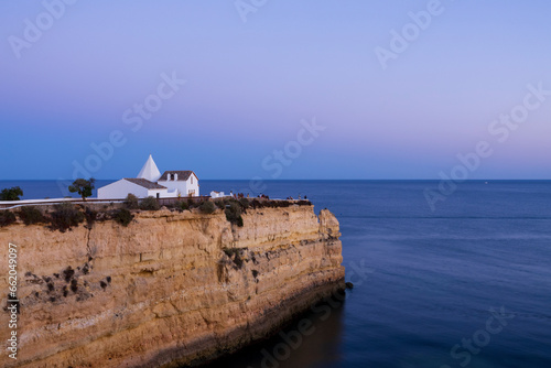 View to the big cliff and the Chapel of Our Lady of the Rock  Igreja de Nossa Senhora da Rocha . Dreamy tranquil sunset scenery.  Porches  Algarve  Portugal