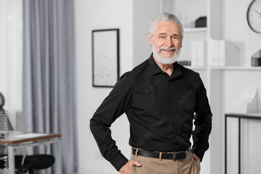 Portrait of handsome senior man in black shirt at home. Space for text Portrait of handsome senior man in black shirt at home. Space for text