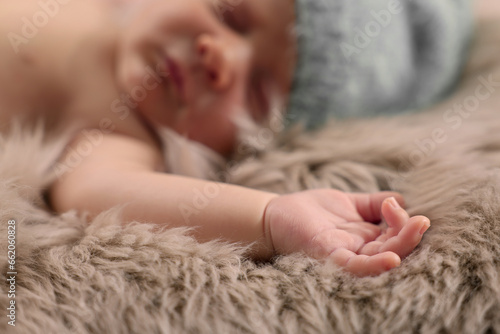 Cute newborn baby sleeping on fluffy blanket, selective focus