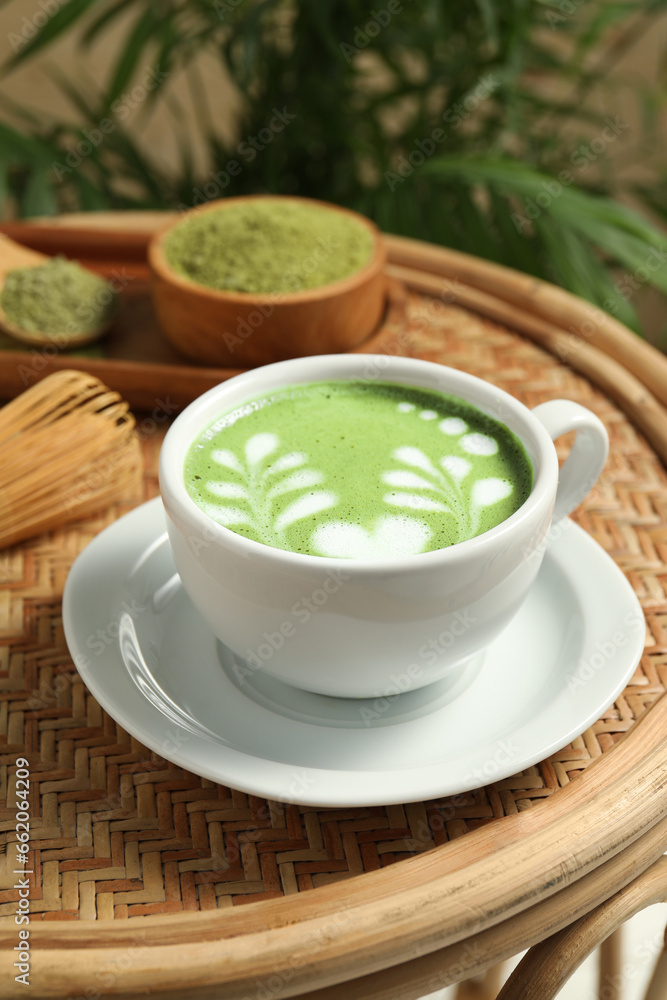Delicious matcha latte in cup on table Delicious matcha latte in cup on table