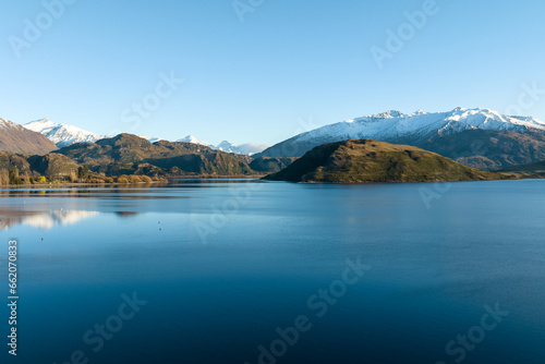 Dawn scenery at Glendhu bay campground looking across Lake Wanaka towards the snow capped mountains in Mt Aspiring National Park © Stewart