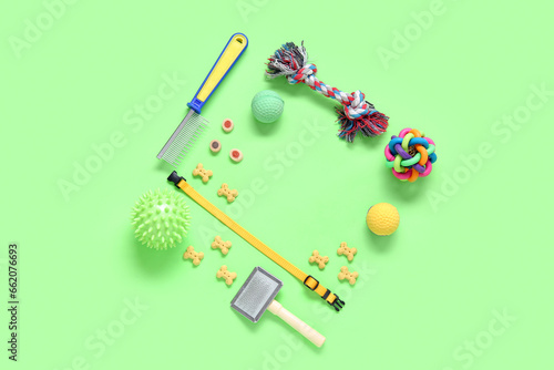 Frame made of pet care accessories and food on color background
