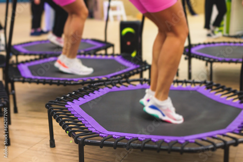 Foto Trampoline fitness jumping training, group of young fit women in sportswear jump