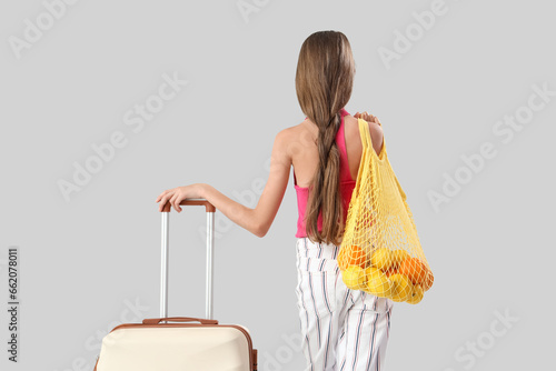 Little girl with suitcase a...