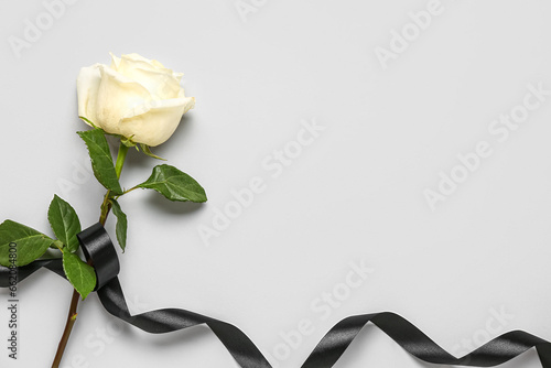 Fototapeta Naklejka Na Ścianę i Meble -  Beautiful rose and black ribbon on white background