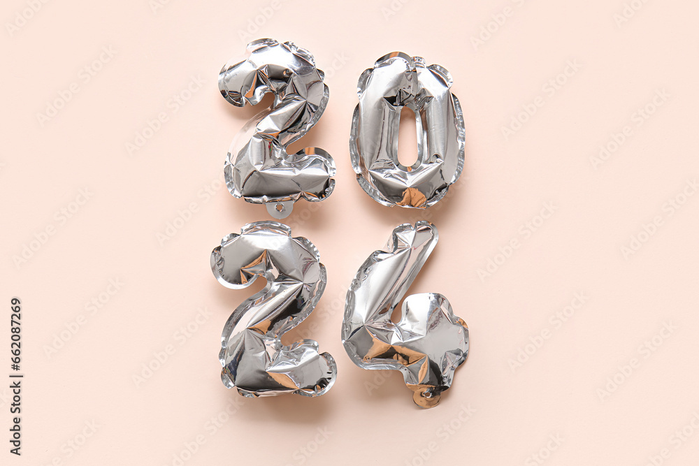 Figure 2024 made of balloons on beige background Figure 2024 made of balloons on beige background