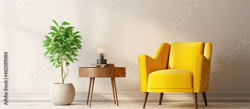 Real photo of a sunny living room with yellow armchair wooden table herringbone floor and white walls With copyspace for text © 2rogan