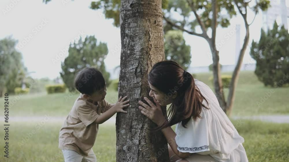 Happy funny. Asian mother and son playing hide and seek in the park. Happy funny. Asian mother and son playing hide and seek in the park.