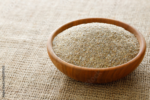wheat bran in bowl on table with sackcloth