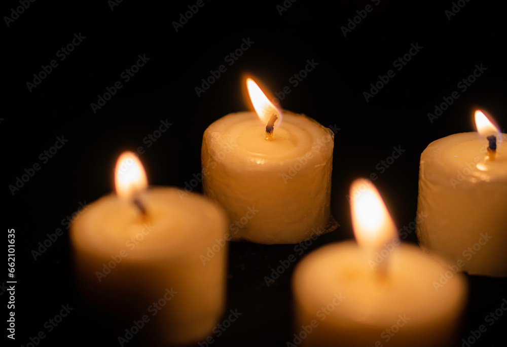 Candles light. Christmas candles burning at night. Abstract candles background. Golden light of candle flame. Candles light. Christmas candles burning at night. Abstract candles background. Golden light of candle flame.