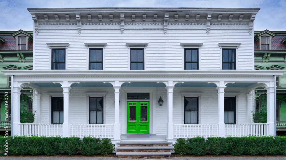 Old fashioned white clapboard house with wide porch