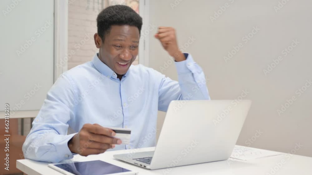 African Businessman Shopping Online on Laptop in Office African Businessman Shopping Online on Laptop in Office
