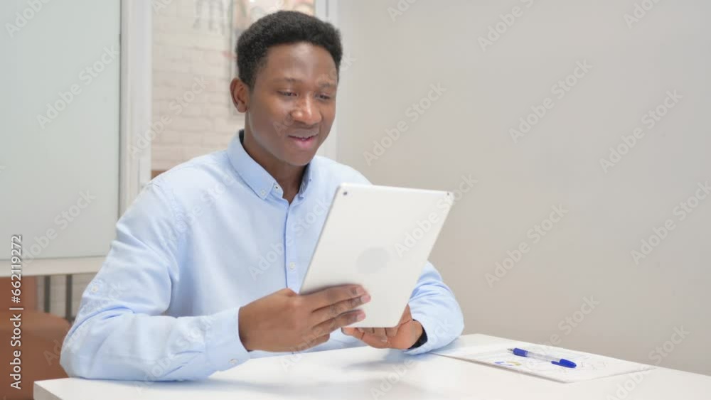 African Businessman Doing Video Chat on Tablet in Office African Businessman Doing Video Chat on Tablet in Office