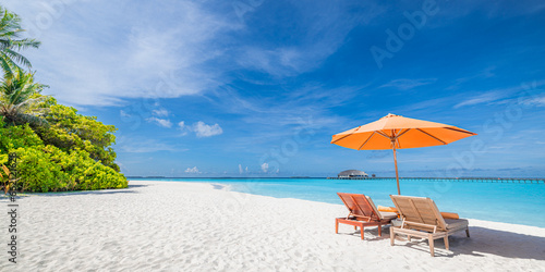 Fototapeta Naklejka Na Ścianę i Meble -  Tropical paradise beach sea sand sky coconut palm trees travel tourism. Chairs umbrella love couple. Luxury best vacation popular holiday destination. Exotic beach resort. Beautiful travel background