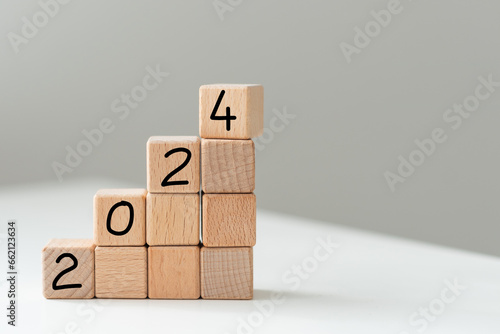 The inscription 2024 on wooden blocks on white background. Letter text on wooden cube.