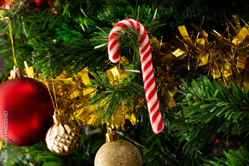 Close up of christmas tree with candy cane, baubles, decorations and copy space