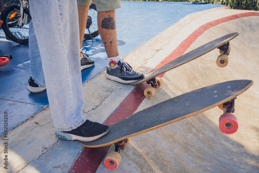 Young happy couple with skateboards enjoy longboarding at the skatepark Young happy couple with skateboards enjoy longboarding at the skatepark