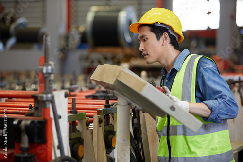 factory workers or engineer smiling and pushing button switch machine control in the factory