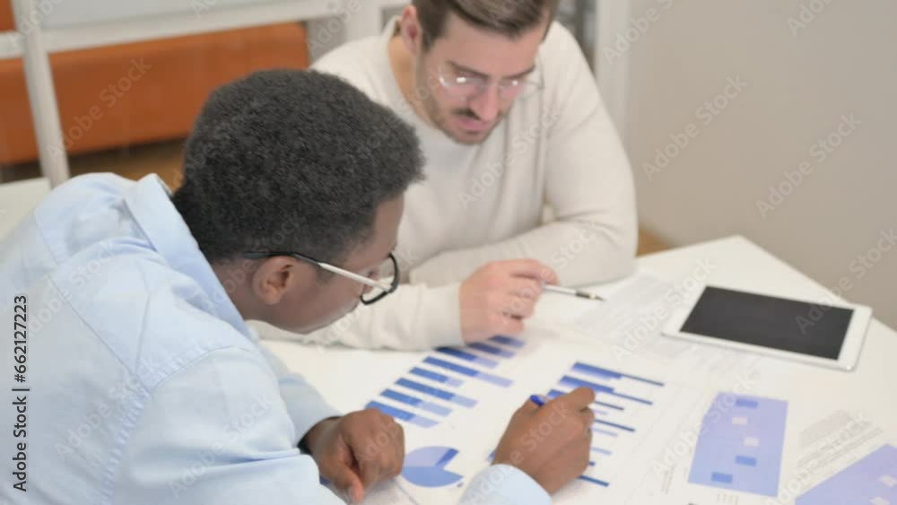 Mixed Race Business People Discussing Business Report Mixed Race Business People Discussing Business Report