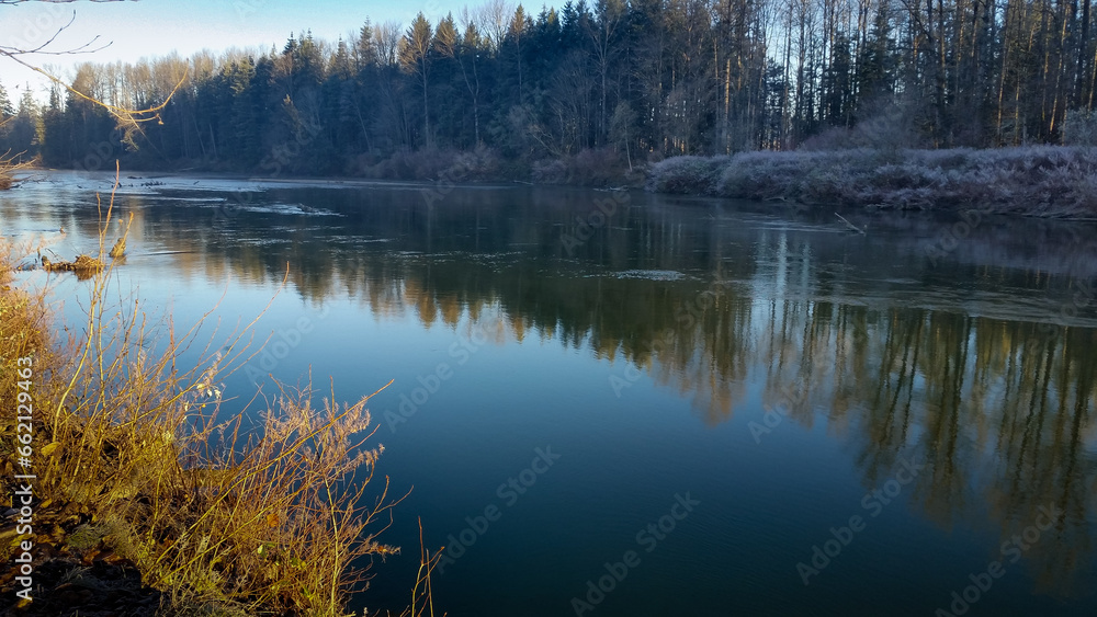 A view of a calm Snoqualmie River during the winter season.