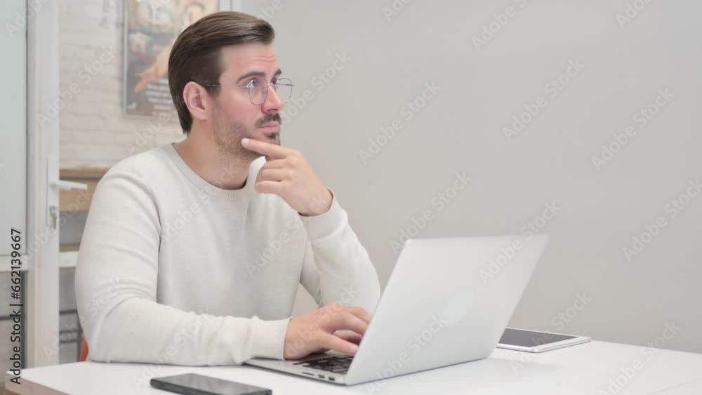 Pensive Middle Aged Man Working on Laptop Pensive Middle Aged Man Working on Laptop