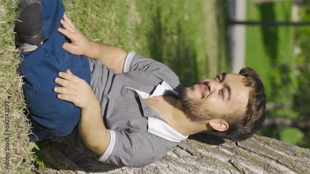 Vertical Video of Dwarf young man in love outdoors, sitting on the floor and happy. Vertical Video of Dwarf young man in love outdoors, sitting on the floor and happy.