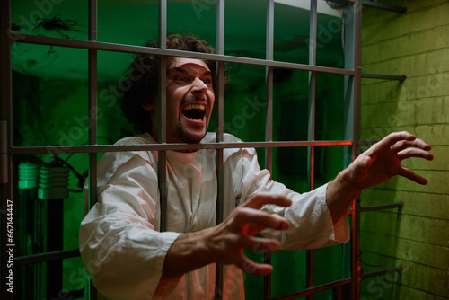 Valokuva Mentally ill male patient with attack of rabies locked in cage ward
