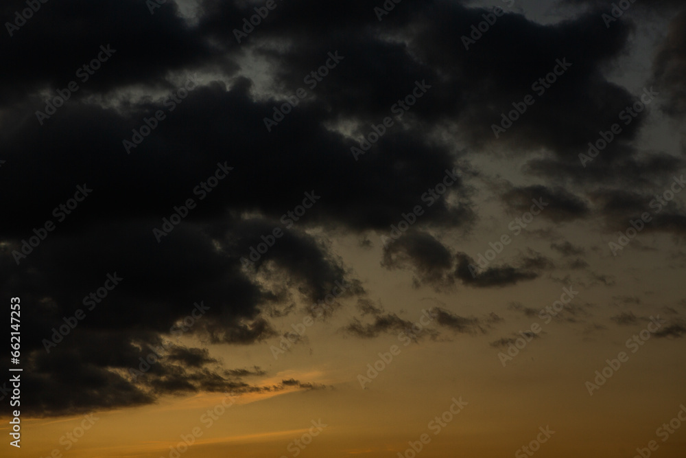 Stormy sky with dark clouds. Natural background. Sky background. Cloudscape, Colored Sunset.