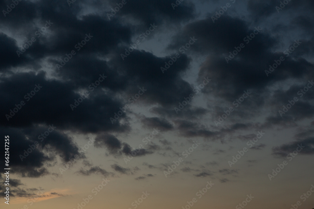Stormy sky with dark clouds. Natural background. Sky background. Cloudscape, Colored Sunset.