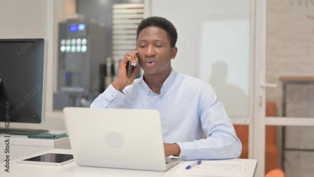African Businessman Talking on Phone with Client African Businessman Talking on Phone with Client