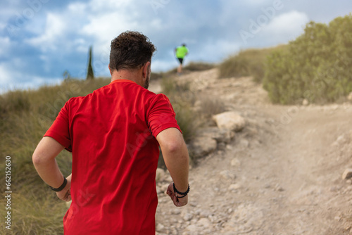 Men running in the mountains on dirt and gravel roads