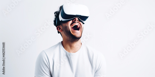Happy young man wearing virtual reality headset and playing a videogame online, Future technology © britaseifert