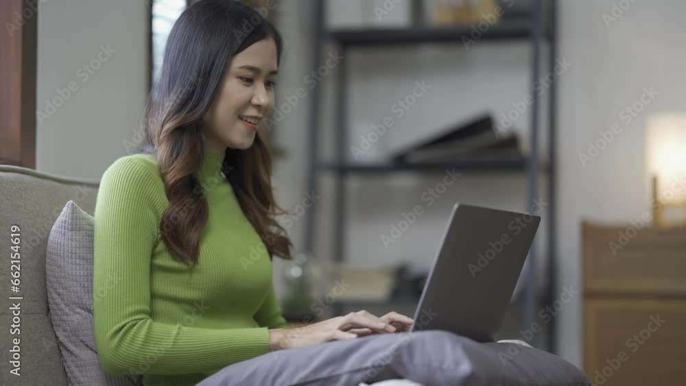 Attractive Asian woman working, surfing the internet, using laptop device, working online from home at living room on floor with cheerful, happy expression. Attractive Asian woman working, surfing the internet, using laptop device, working online from home at living room on floor with cheerful, happy expression.